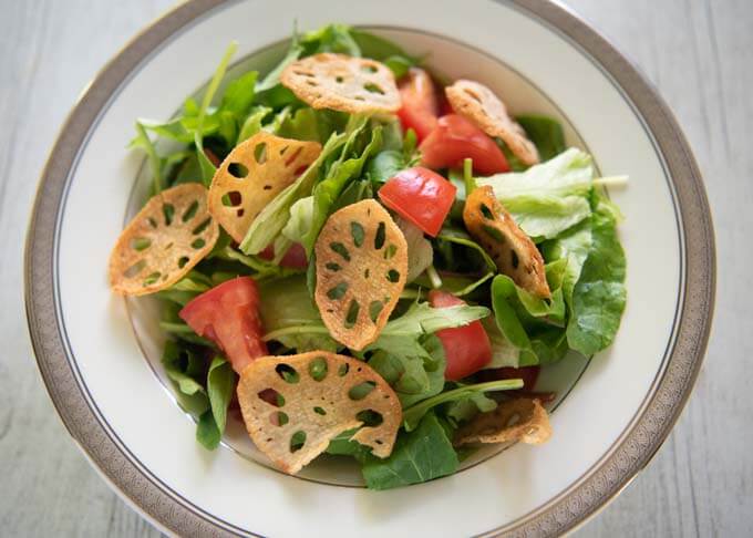 A salad with lotus root chips as toppings.