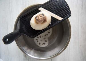 Slicing a piece of Lotus root using my slicer.