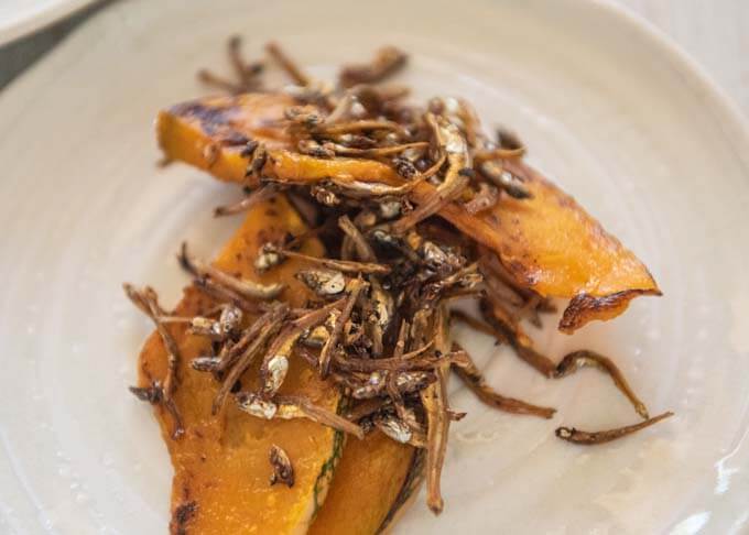 Zoomed-in photo of Sautéed Pumpkin with Crunchy Baby Anchovies.