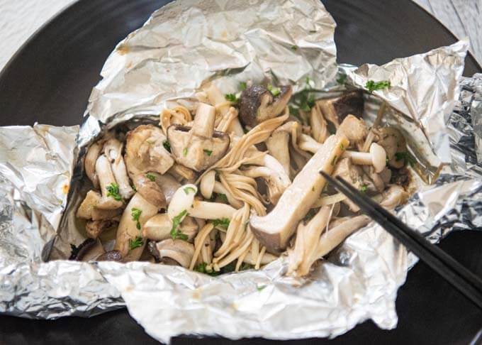 Mixing the mushrooms before eating Miso Butter Asian Mushrooms in Foil.