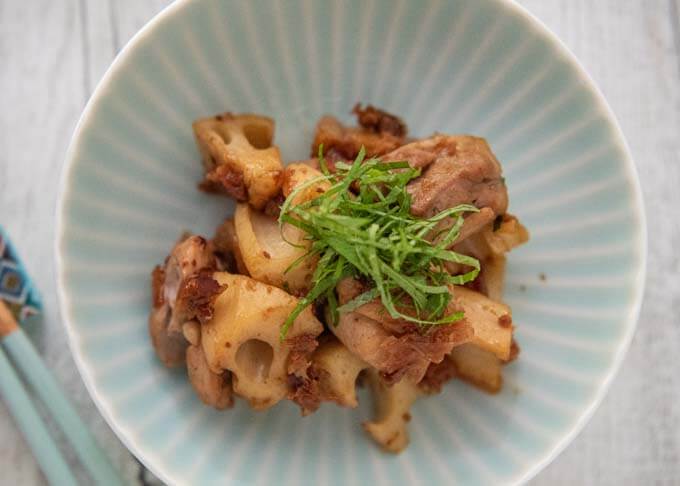 Top-down photo of autéed Lotus Roots with Pickled Plum and Bonito Flakes.