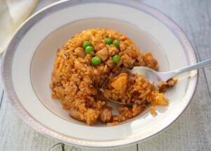 Scooping the dome-shaped Japanese Chicken Rice with a spoon.