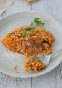 Scooping Chicken Rice with a spoon.