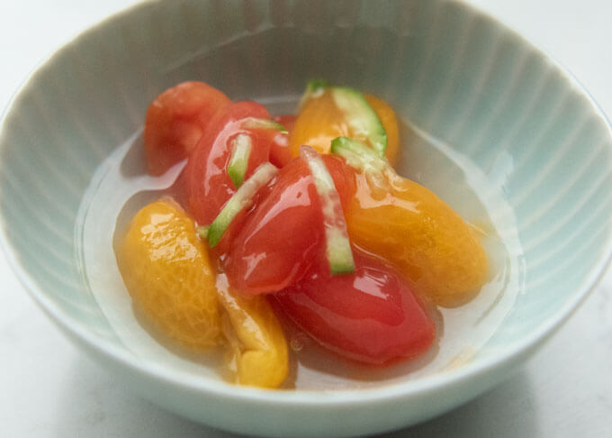 Gin-an poured over marinated tomatoes.