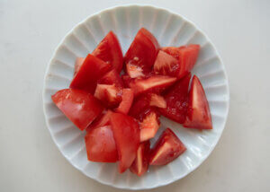 Tomatoes cut into wedges, then halved.