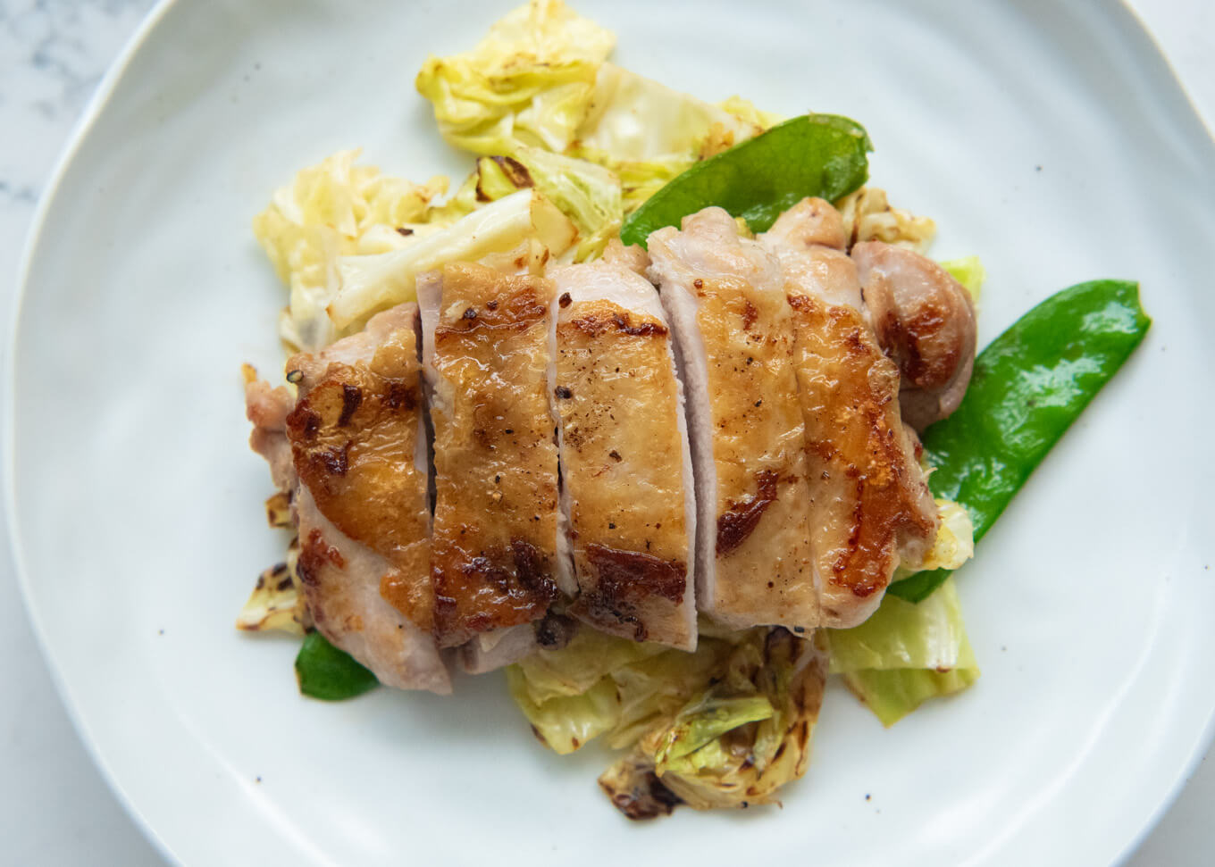 Top-down photo of Crispy Skin Chicken with Yuzu Koshō,