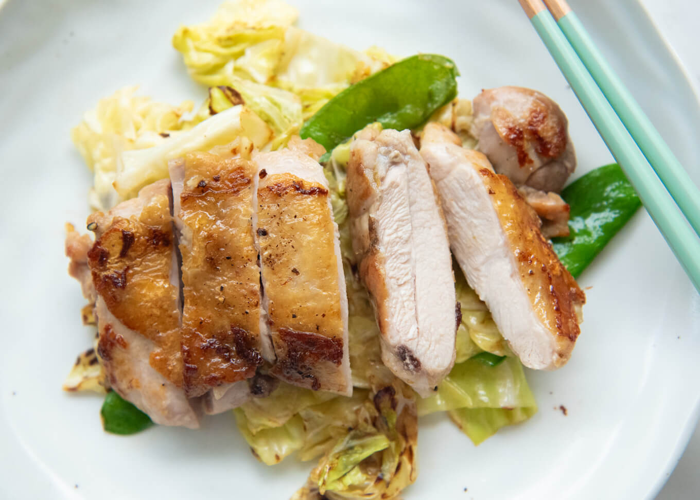 Showing the inside flesh of the sliced Crispy Skin Chicken with Yuzu Koshō.