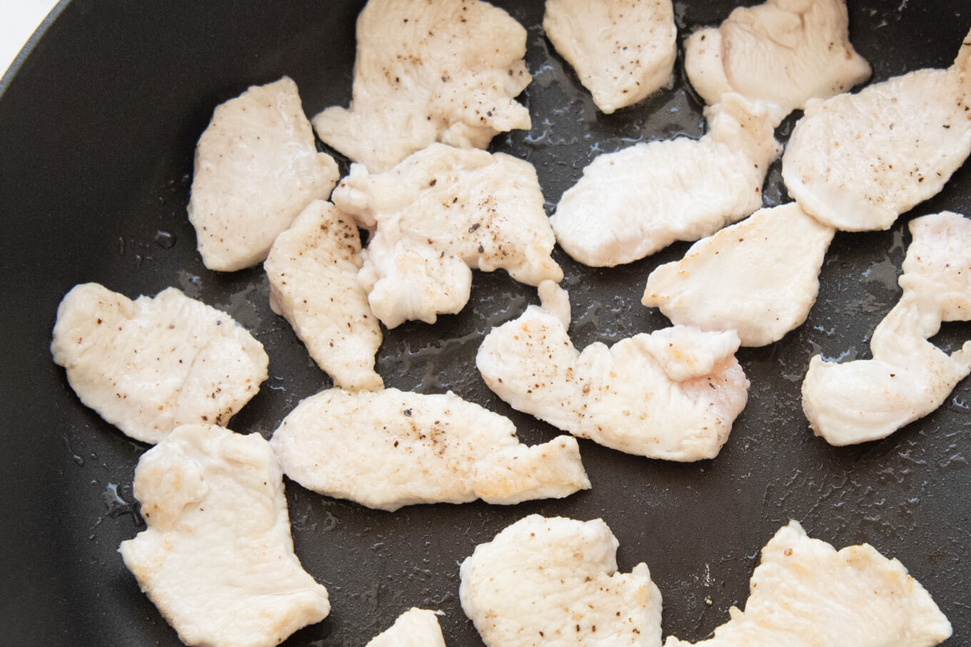 Zoomed-in photo of lightly seared chicken pieces.
