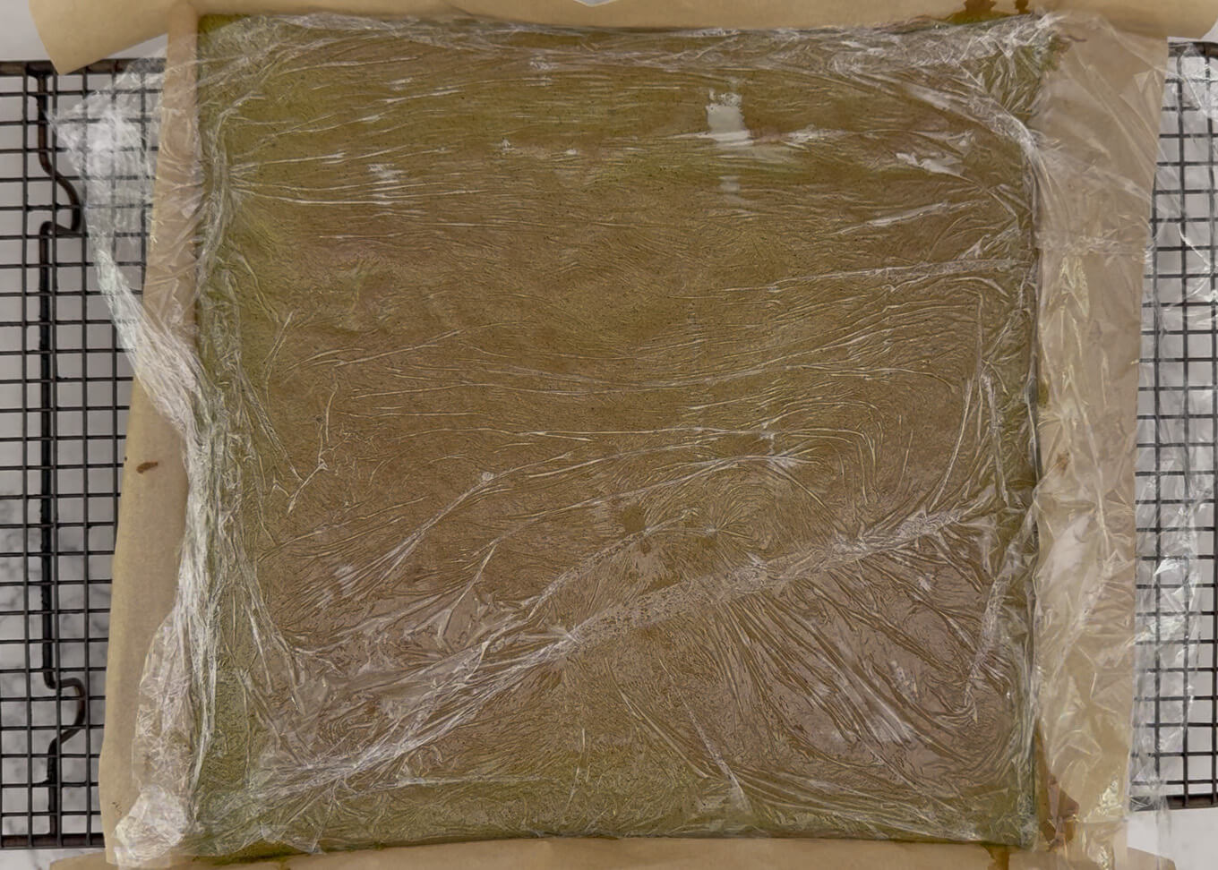 Cover the surface with cling wrap as soon as the cake is take out of the oven.