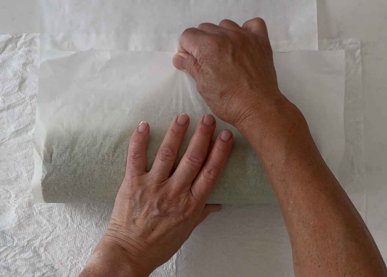 Use baking paper to assist the sponge cake roll.