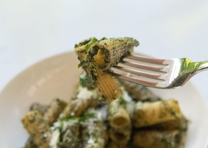 Picking up a couple,of Shiso Pesto Pasta pieces with a fork.