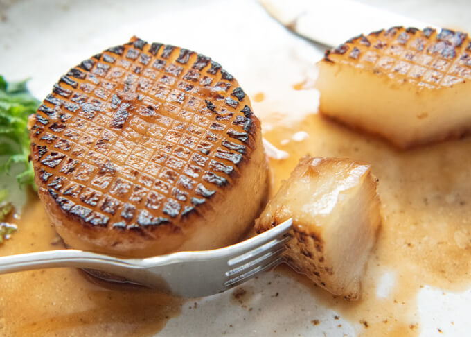 Showing the semi-transparent onside flesh of the cooked daikon